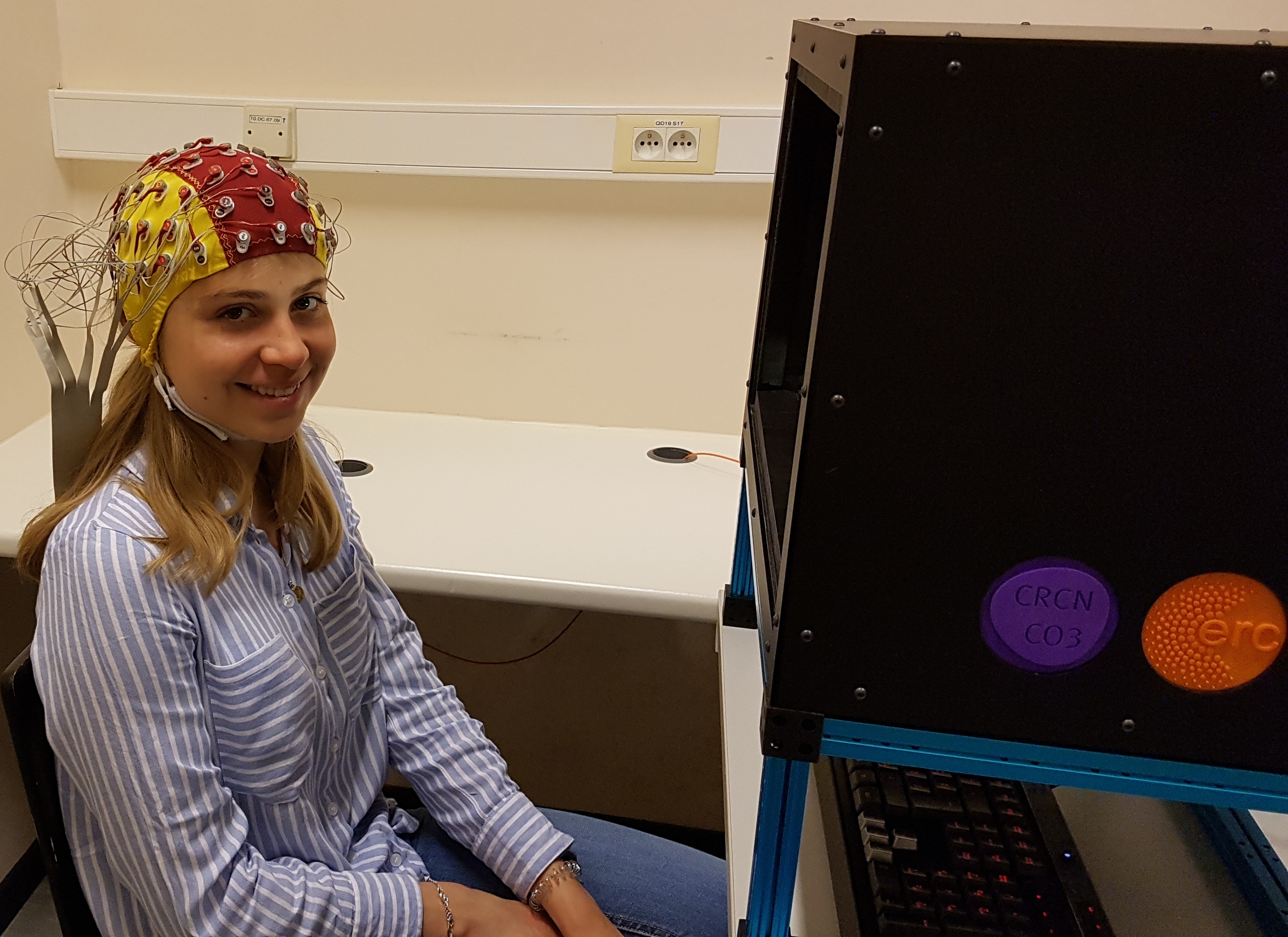 Student wearing EEG cap to measure voltage changes in the brain.